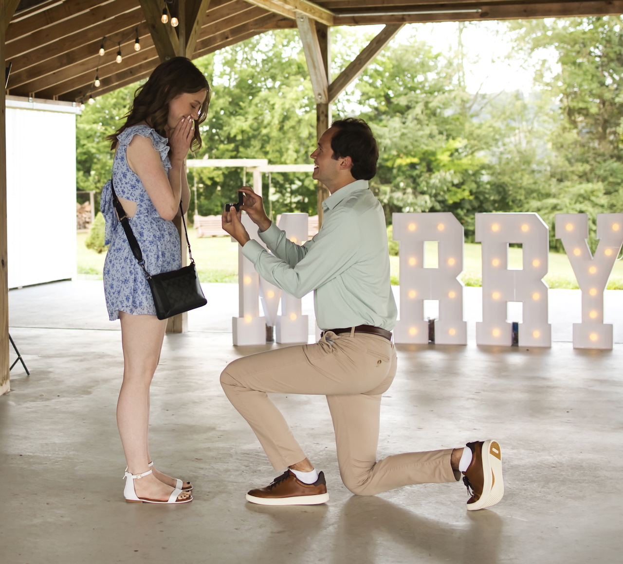Josh down on one knee proposing to Jessika